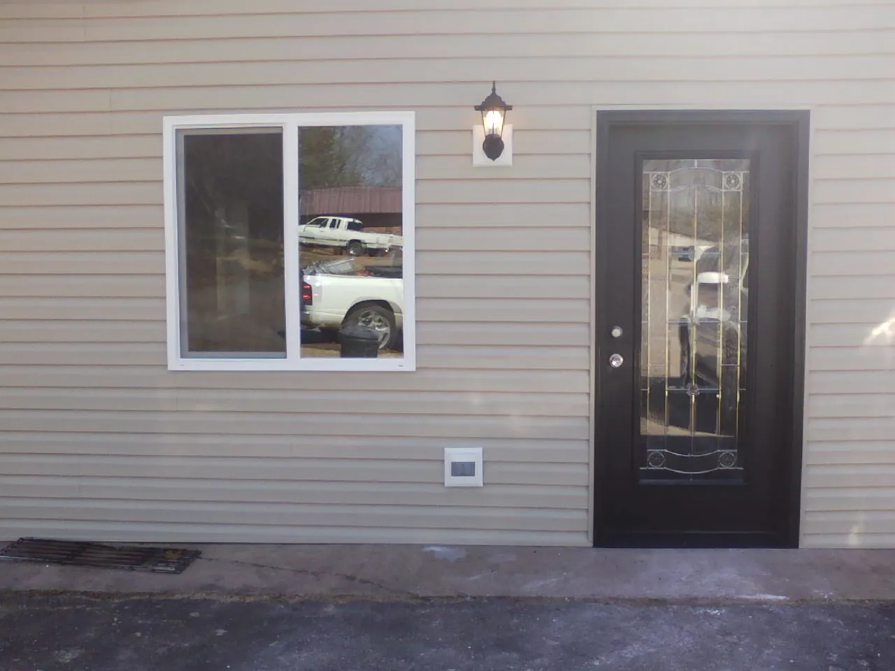 New siding, window and entry door on the side of an addition in Liberty Center