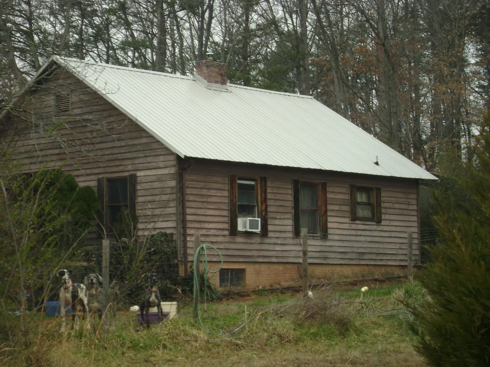 White metal roof on an old wood sided farmhouse, from a Metal Roof Installation job in Liberty Center